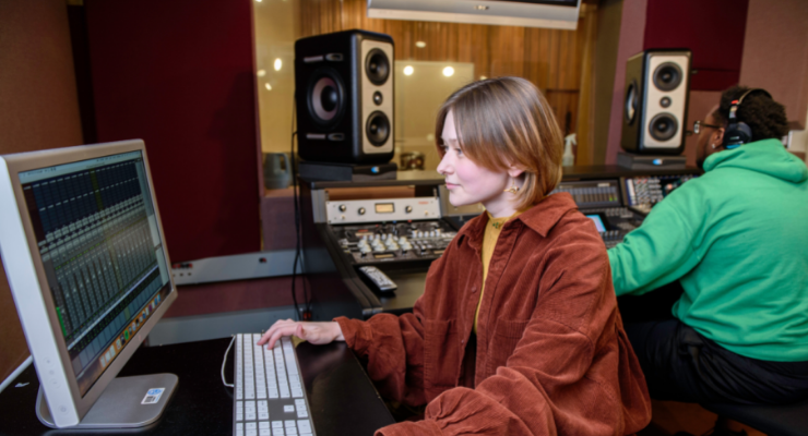 lady and man in recording studio at controls